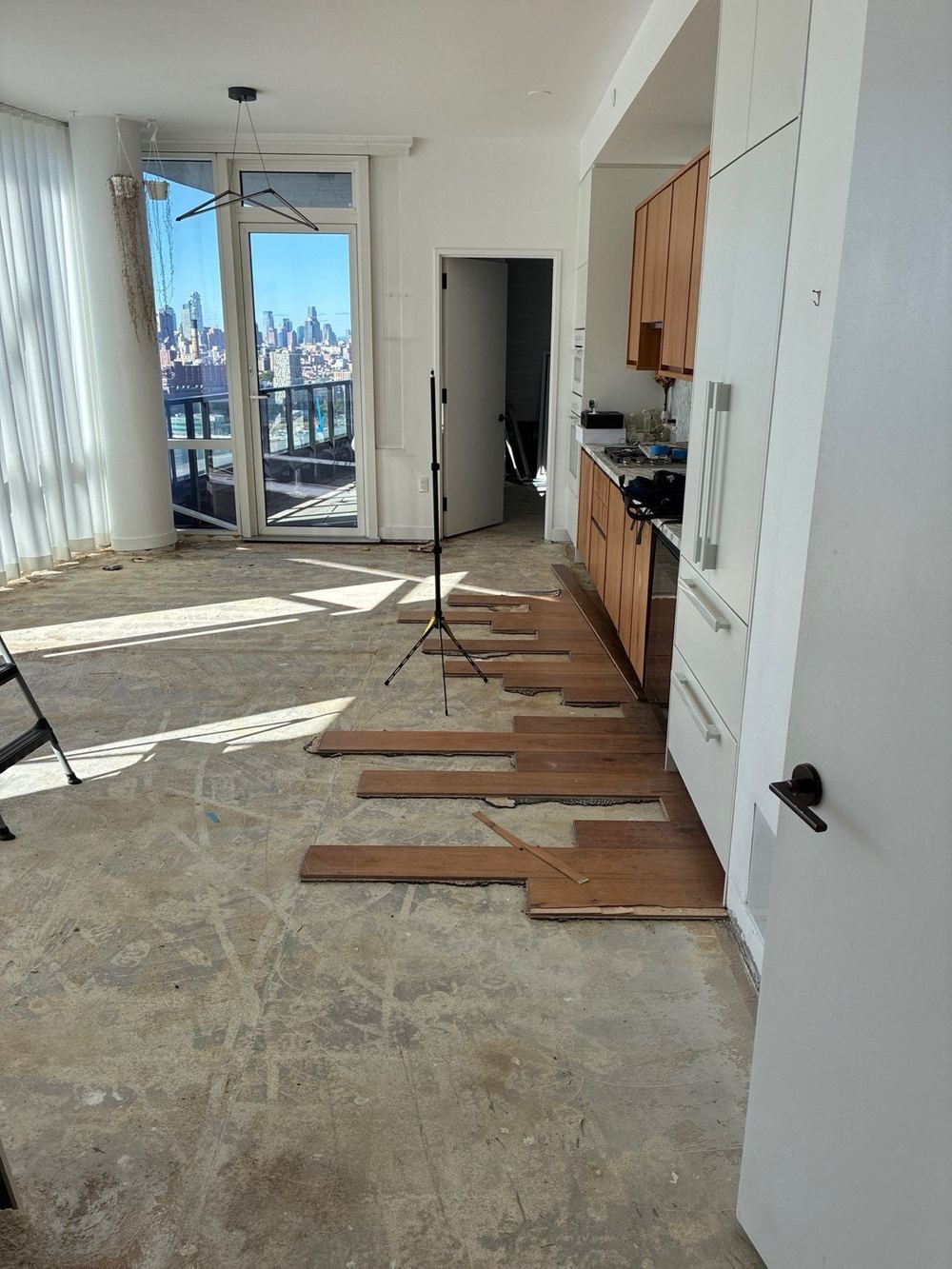 Condo wood floors torn up after water damage.